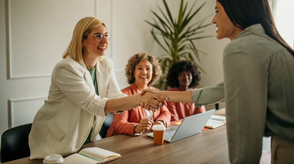 Founder and first hire celebrating—the right time to hire for your business is now.